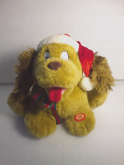 T.L. Toys HK Ltd. Animated Christmas Dog Plush Stuffed Animal Wearing Santa Hat