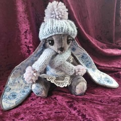 Adorable handmade rabbit plush with a dress, scarf, and hat